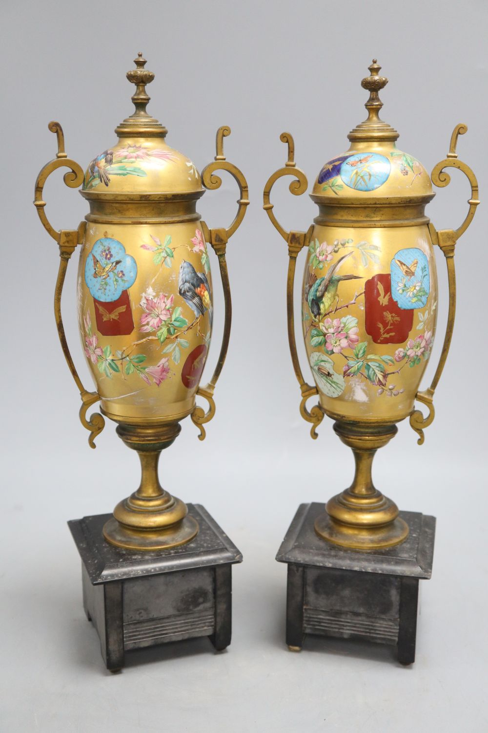 A pair of Victorian Aesthetic movement gilt metal and porcelain vases, height 40cm